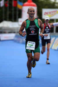 Graeme Purdy, who is a client of The Putney Clinic of Physical Therapy, competing in the PruHealth World Triathlon in London in September 2013, running for Ireland.